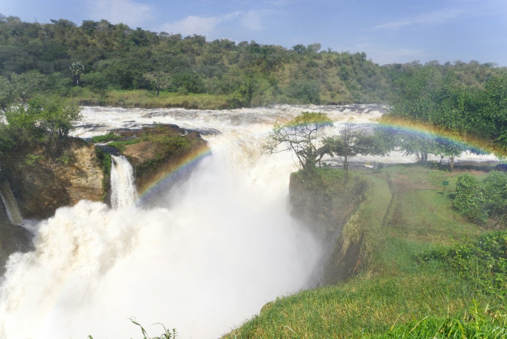 Murchison Falls with rainbow, mist and lush green hills, Uganda