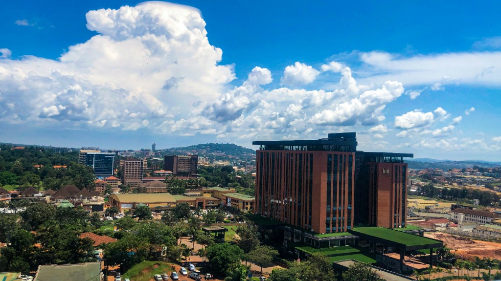 Kampala skyline with modern buildings, green hills and bright sky, Uganda