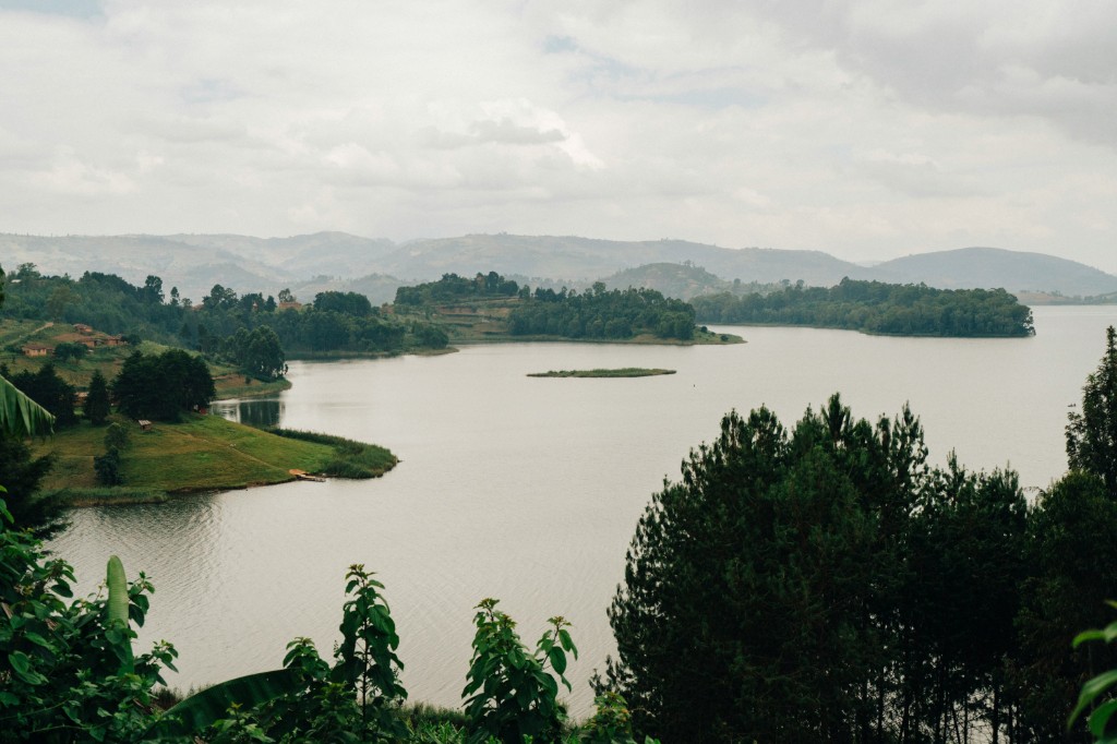 Lake Bunyonyi with islands, misty hills and calm water under soft clouds, Uganda